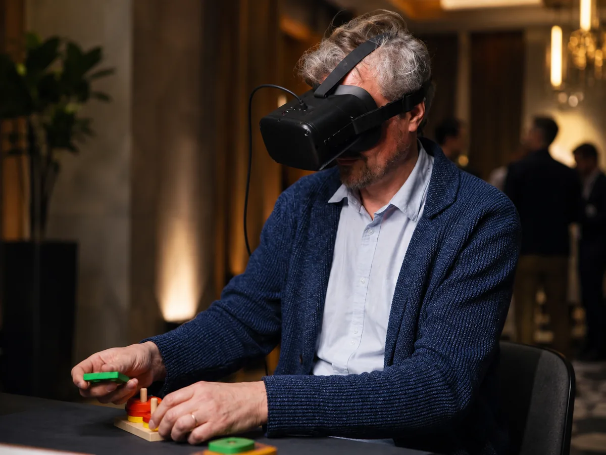 old man playing interestin avatar game with soeacial glasses