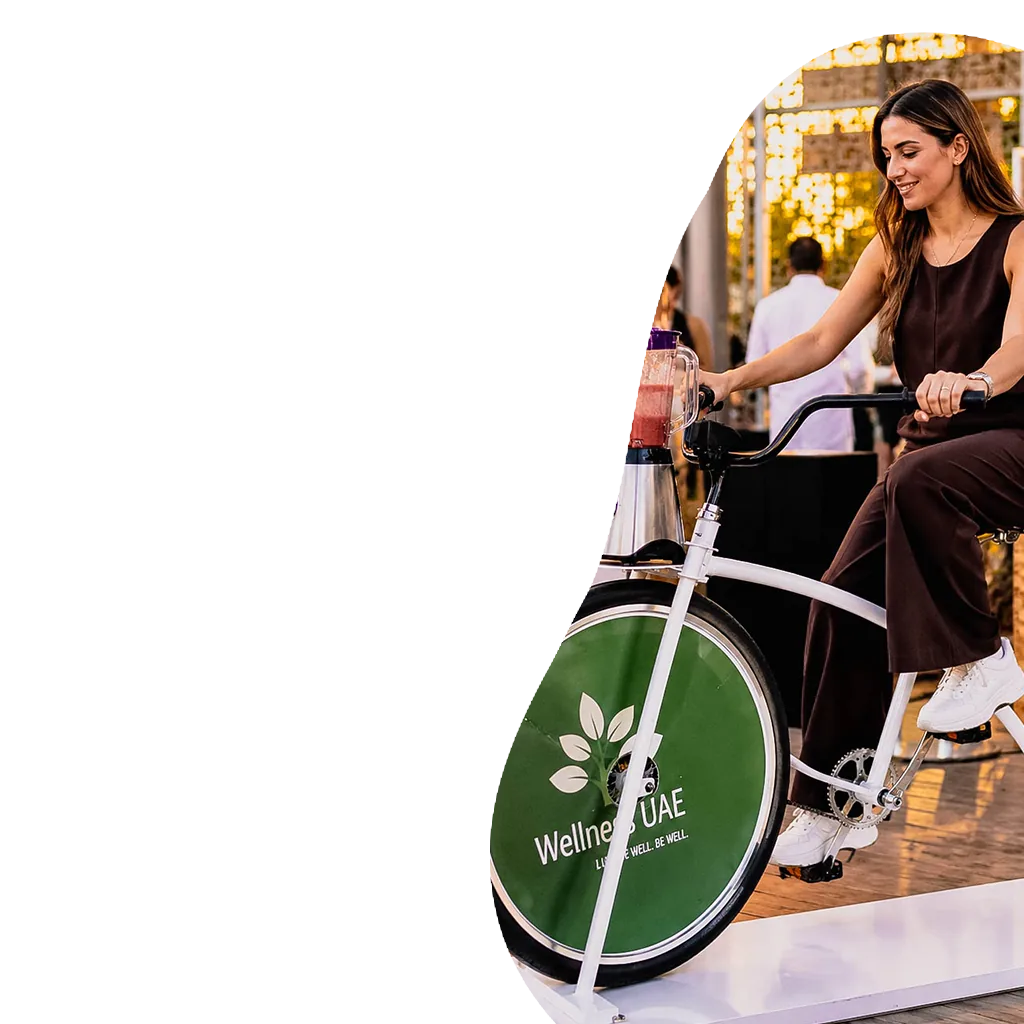 lady riding bike smoothie shaker at an event