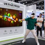 guy playing in VR Fruit Ninja game