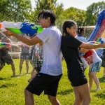 adults playing water battle
