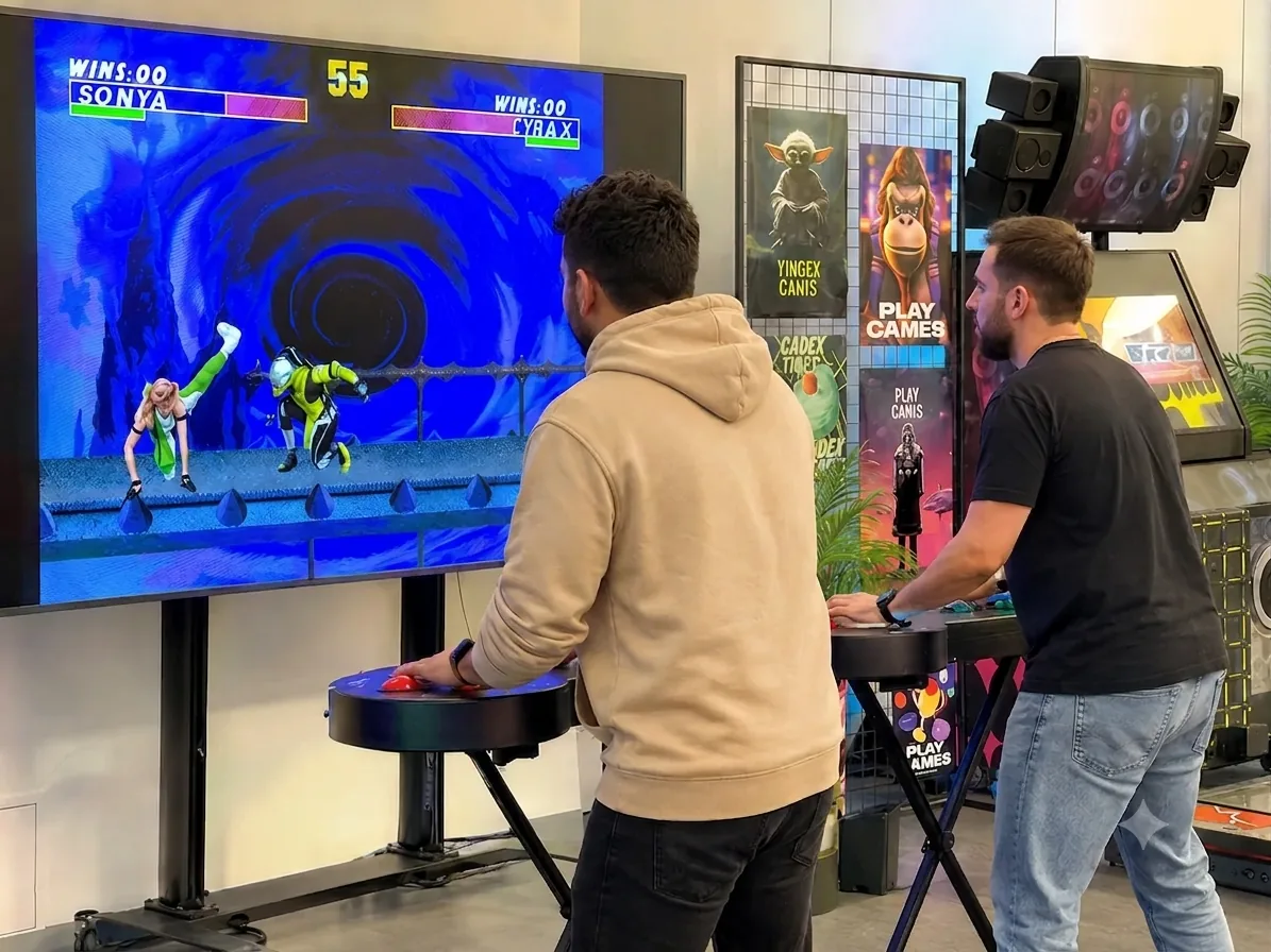 guys playing with giant sega controllers